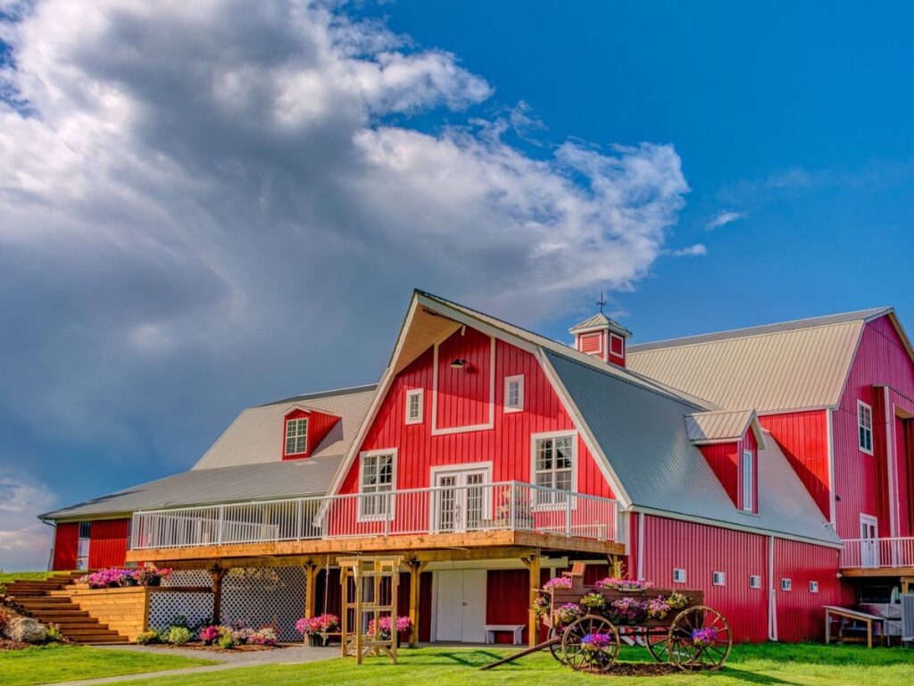 red metal exterior residential home in the country on a blue sky day